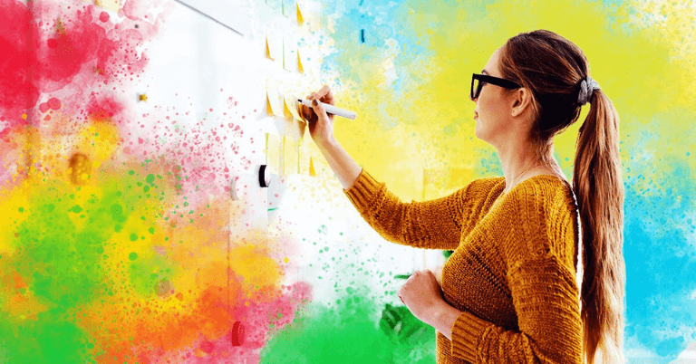 Image of an individual writing on a whiteboard, learning about soft skills to improve performance at her work