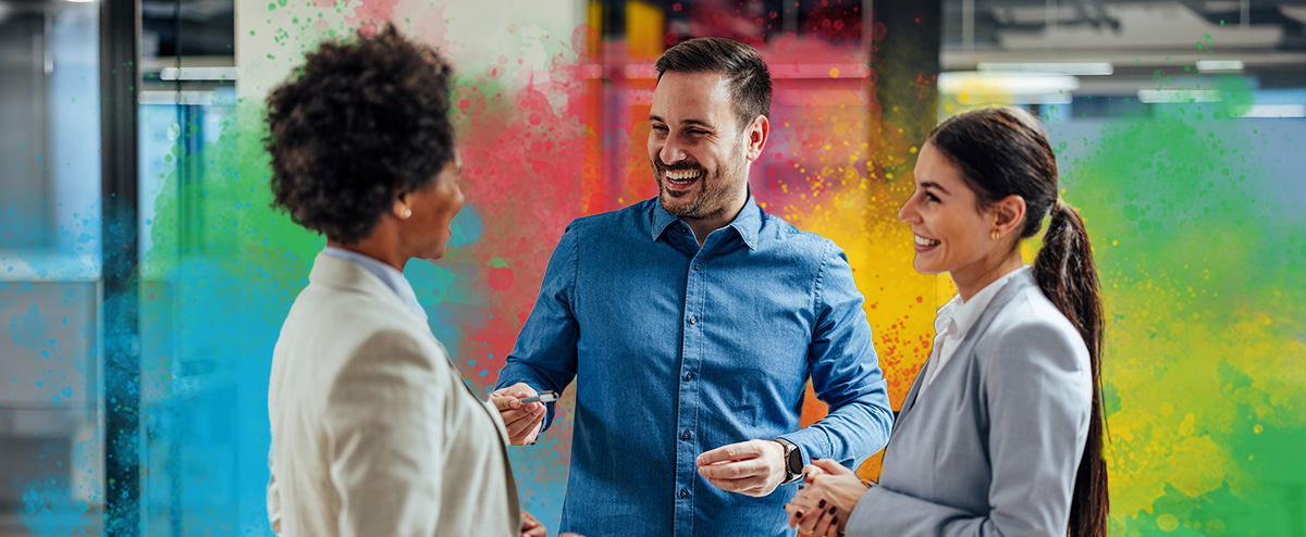 Three employees of different DiSC styles chatting happily