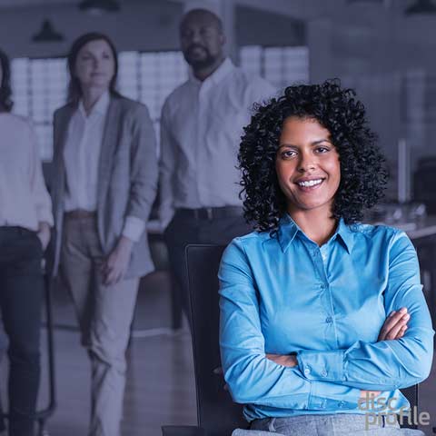 Woman in an office, smiling with crossed arms